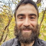 Bearded man with trees in background